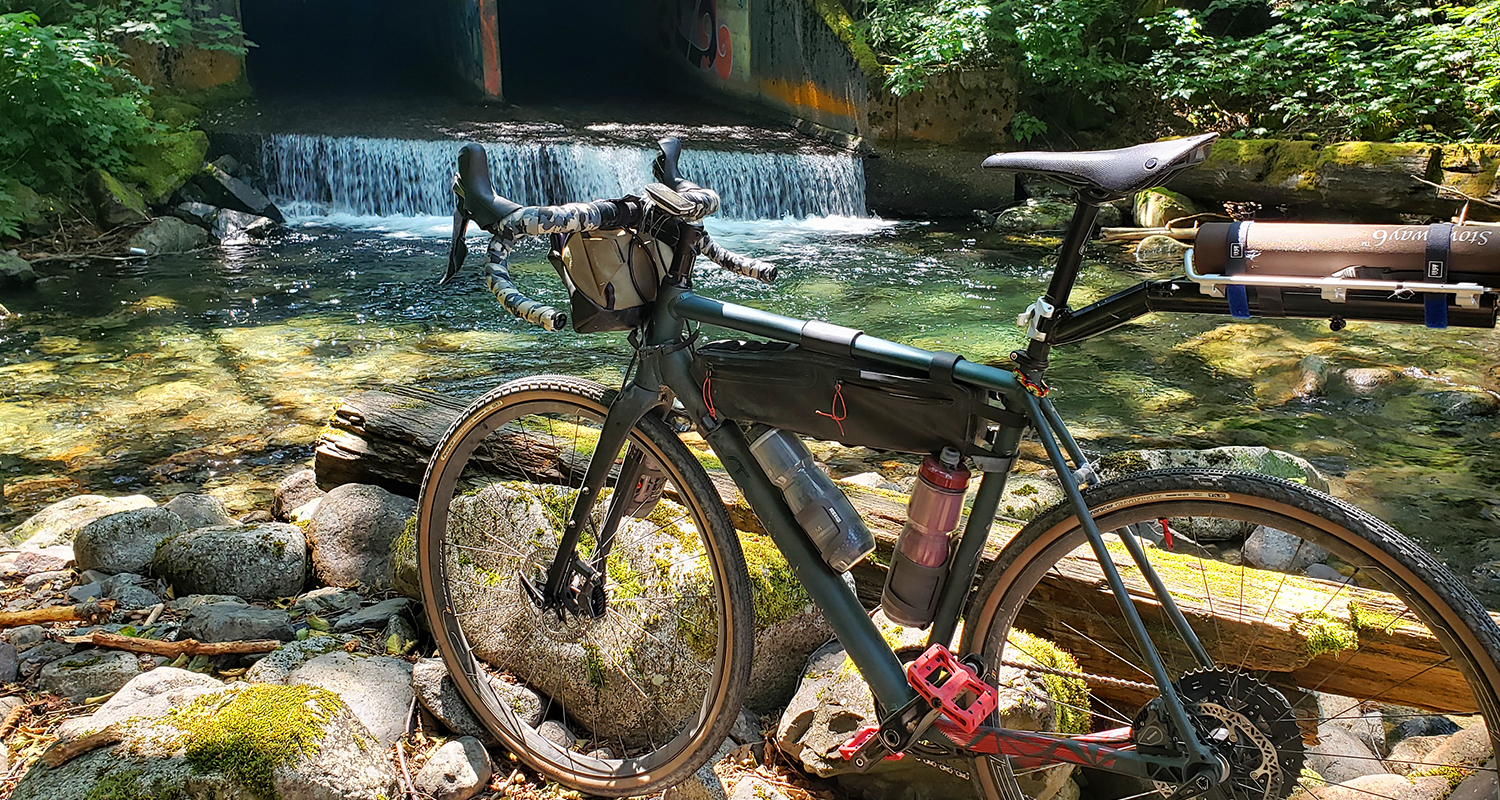 gravel bike in front of small waterfall