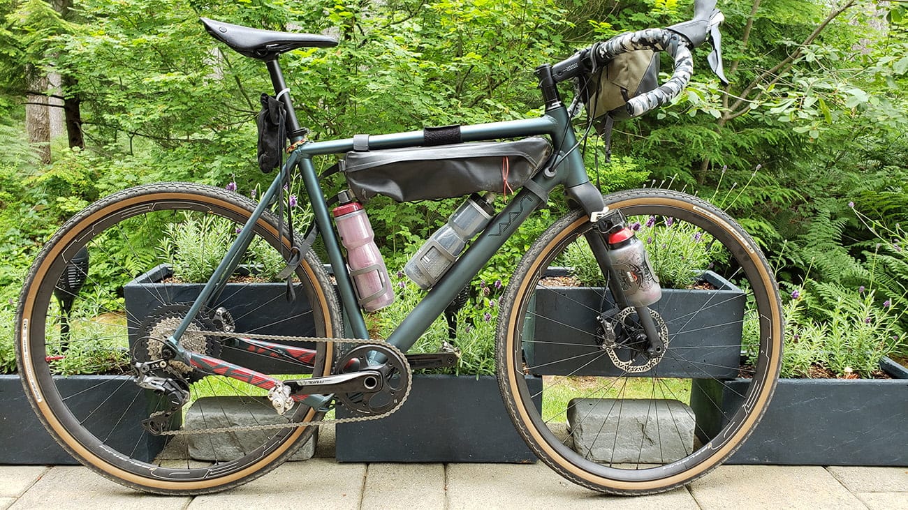 Gravel cyclist descending a forest road in the Cascades