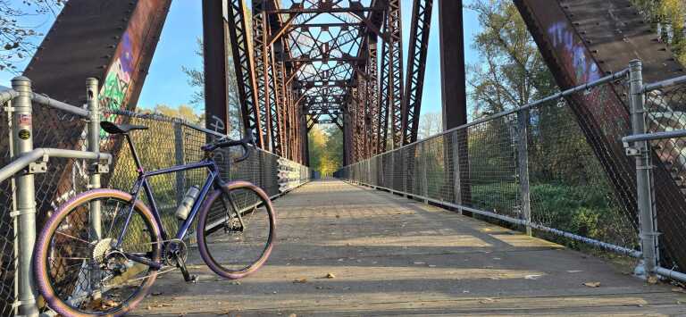 Gravel cyclist on a winding mountain road at golden hour