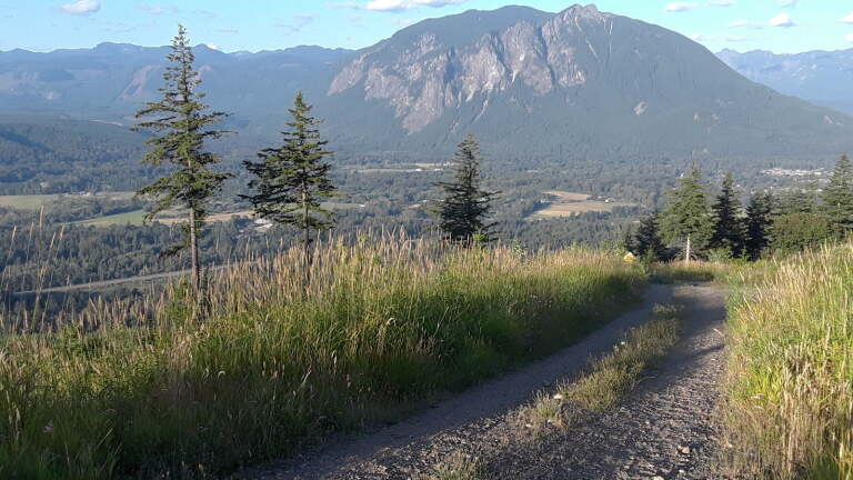 Summit gravel trail with views of Cascade Range, North Bend area