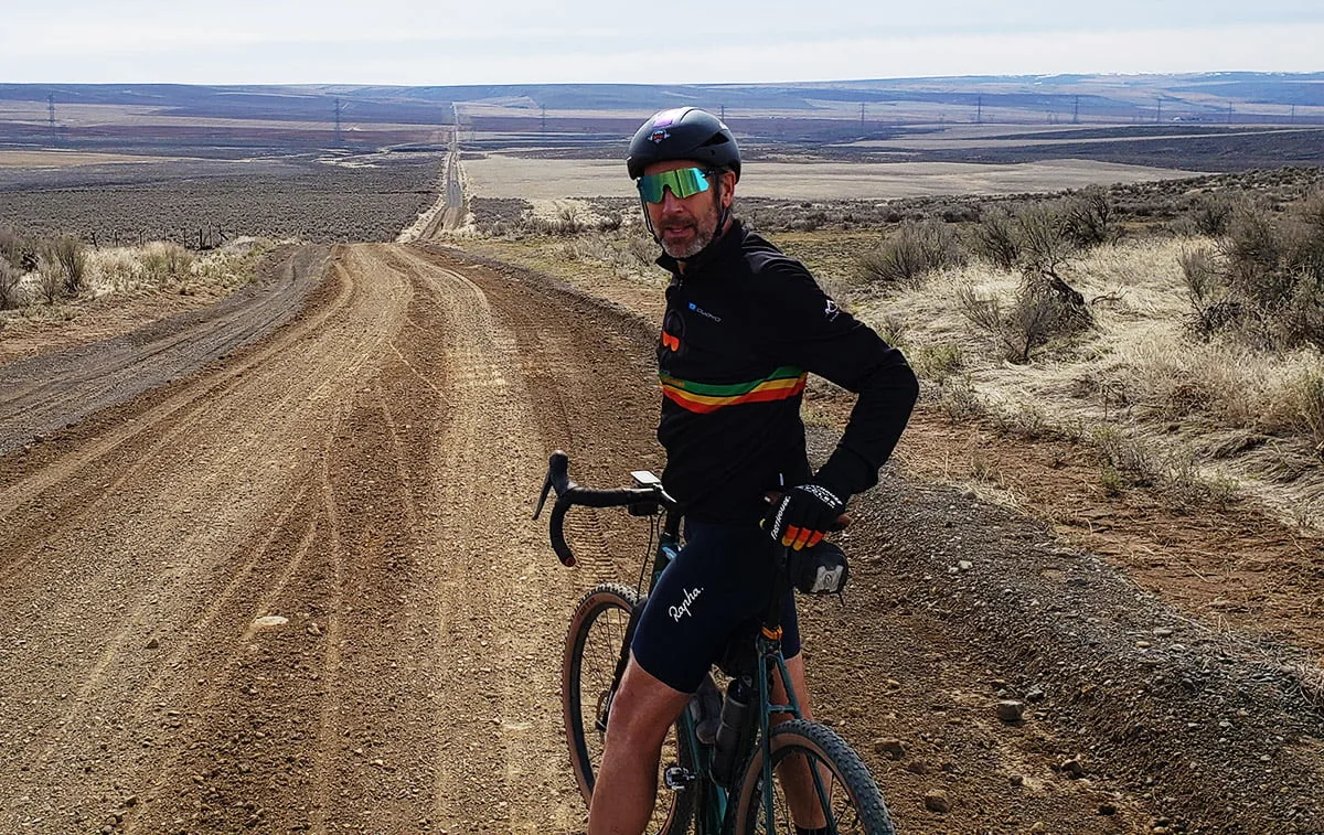 Gravel cyclist on dirt road through Eastern Washington high desert
